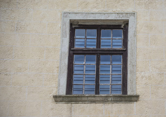 Fototapeta na wymiar Old window in the city in summer day