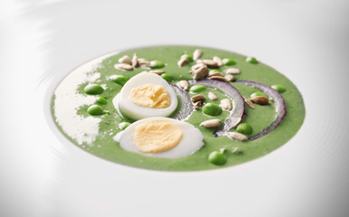 Plate with delicious puree from green peas, closeup