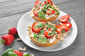 Delicious sandwiches with strawberry, basil and peanut on table