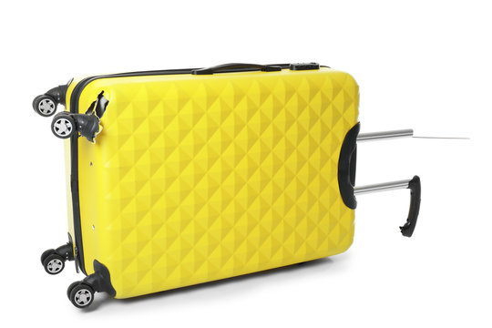 Yellow plastic luggage with broken handle and wheel isolated on white