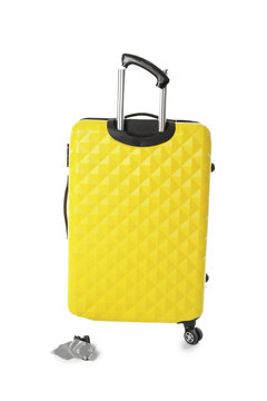 Yellow plastic luggage with broken handle and wheel isolated on white
