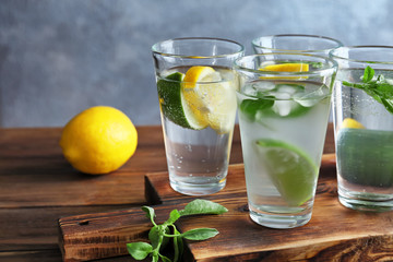 Board with glasses of basil water on table