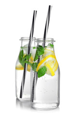 Two bottles with basil water, isolated on white
