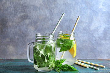 Jars with basil water on table