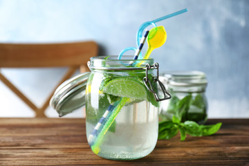 Jar with basil water on table