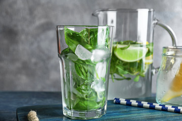 Basil water in glassware on table