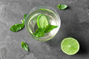 Glass with basil water on table