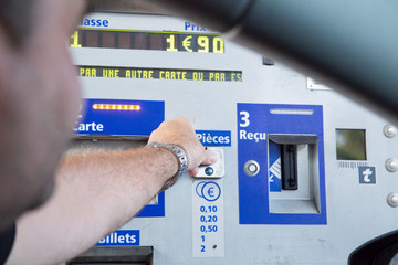 A man pays tolls on the highway