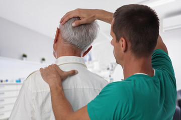 Man having chiropractic back and neck adjustment. Osteopathy, Alternative medicine, pain relief...