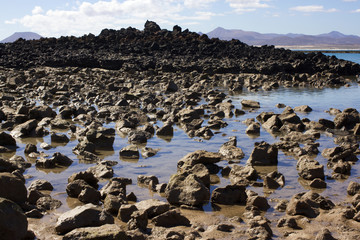Panoramic ocean view. Volcano, black rocks.