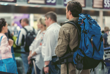 Young guy is waiting for registration to his flight