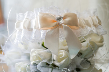 beautiful white bride's garter with flowers