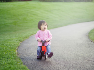 baby girl play bicycle at  outdoor