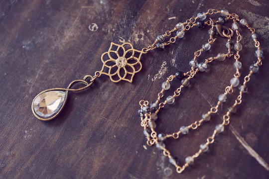 Beautiful romantic necklace on the wooden table