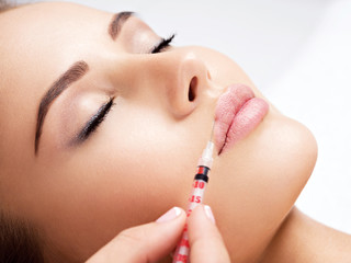 woman gets botox injection in her face