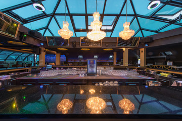 Reflection of chandeliers at bar counter in luxury restaurant