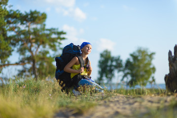 boy with backpack looks into the distance. Adventure, travel, tourism concept