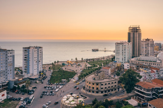 View from above on the embankment of the seaside town of Durres located on the Adriatic coast. Sunset sunset overlooking the Venetian Tower with a cafe on the roof.