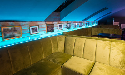 Luxury discotheque interior with big luxury green sofas
