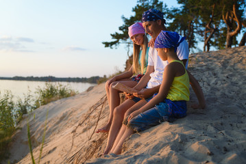 Happy family looks on map. Adventure or travel and tourism concept