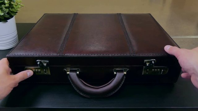 Opens the case with a mask and a gun