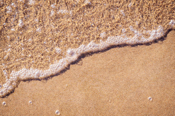 Fototapeta na wymiar Shallow water line on a sandy beach top view