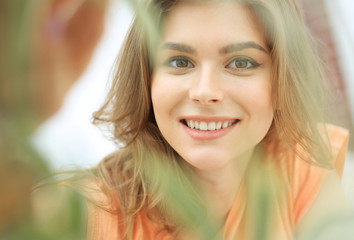 portrait of smiling woman face on blurred background.