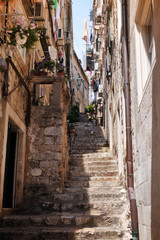 Fototapeta na wymiar View of picturesque street with old stone steps