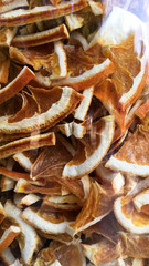 Dry slices orange in a glass bottles. Dry slices orange for perfumes, cosmetics, alternative medicine, herbal tea and bath. Colored organic herb. 