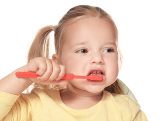 Cute little girl brushing teeth, isolated on white