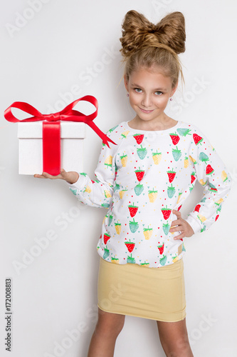 Gracious Little Girl With Blond Hair And Blue Eyes Standing On A