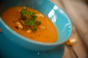 Pumpkin soup served with parsley and pumpkin seeds / Autumn concept