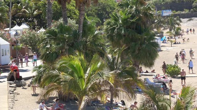 Costa Adeje Tenerife Spain : Tourists on the beach of Playa del Duque