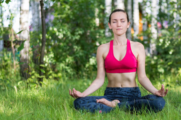 A young Russian woman meditating in the Park