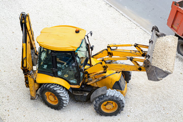 Yellow tractor leads road works