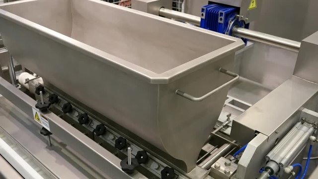 Food factory automated robotic production machine. Conveyor product line for cooking and packing rations and foods. Robotics and automatic lines used instead of human labor on factories and plants.