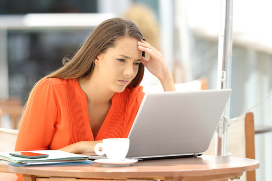 Worried entrepreneur reading bad news on line