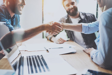 Business partnership handshake concept.Photo coworkers handshaking process.Successful deal after great meeting.Horizontal, blurred background.