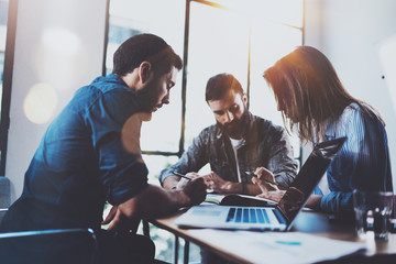 Teamwork brainstorming process.Young man working together with partners in modern office...