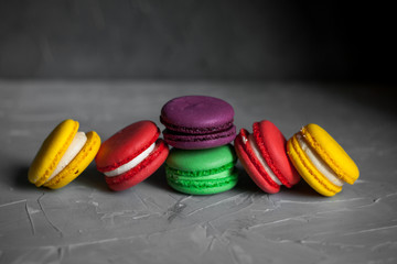 Sweet and colorful french macaroons or macaron on gray background, Dessert.
