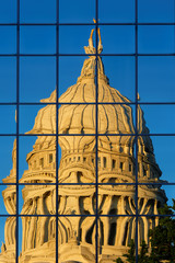 The reflection of Wisconsin state capital on a glass building at sunset Madison, Wisconsin USA. The...