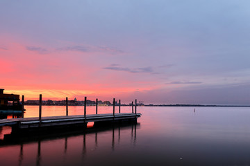 Obraz premium Molo rybackie i panoramę Madison of Wisconsin o zachodzie słońca z Olin Turville Park. Zdjęcie przedstawiające stolicę stanu i jezioro Monona z odbiciami, Madison, Wisconsin, USA.
