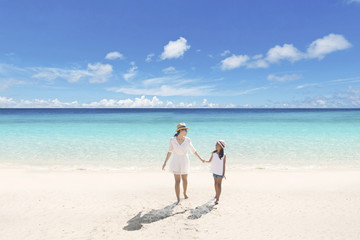 Mother and child walking on the beach