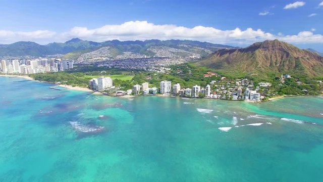 Drone flies up and over the city of Honolulu from off the coast