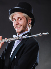 Elegantly dressed musician holding flute © anetlanda