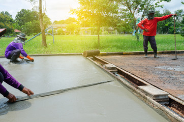 Construction workers are pouring concrete to build roads.Concrete road construction