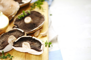 Fototapeta na wymiar Fresh raw shiitake mushrooms on cooking board