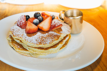 Stack of buckwheat pancakes with fresh berries. Selective focus