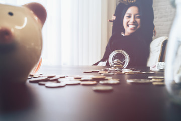 Beautiful young business girl saving money for holiday season, saving money concept