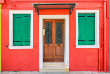 Obraz na płótnie Canvas Picturesque windows with shutters of red house on the famous island Burano, Venice, Italy